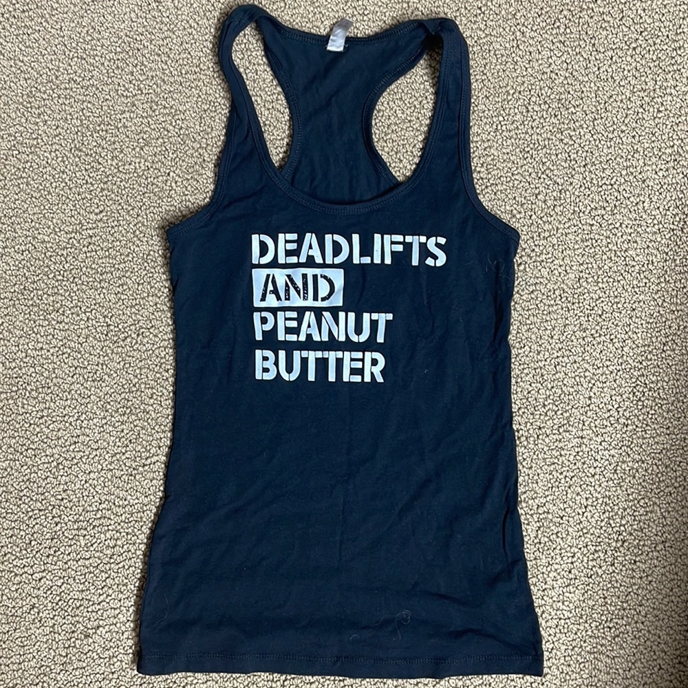 Next Level apparel tank. Tag says medium. I think it fits tight, like a small.